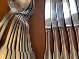 a lot of silver spoons and spoons on a table