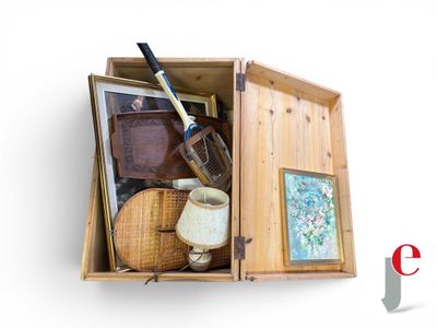 a wooden box filled with items that include a knife and a painting