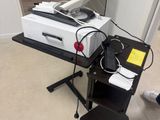 a printer sitting on top of a stand in a room