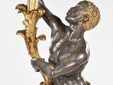 bronze statue of a man holding a mirror in his right hand