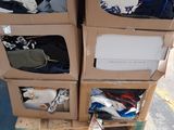 a stack of boxes with clothes on top of them