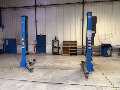 two blue lifts in the garage of a building