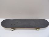a skateboard that is sitting on a white surface
