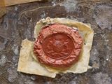 a wax seal on a piece of paper on a table
