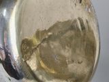 a close up of a silver vase on a table