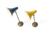 pair of brass and blue lamps on a white background