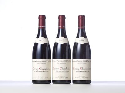 three bottles of wine are lined up on a table