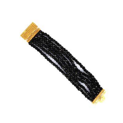 a close up of a black beaded bracelet on a white background