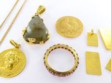 several gold and silver jewelry including a ring, pendant, and a coin
