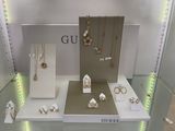 a glass display case with a lot of jewelry on it