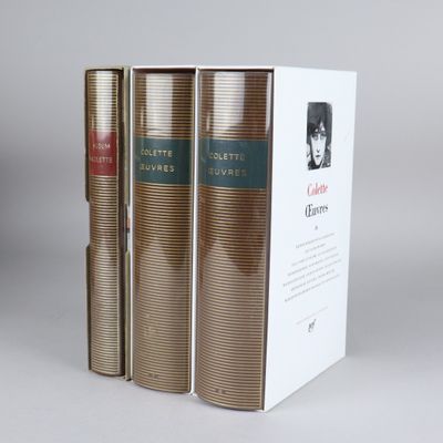 three books are stacked on top of each other on a table