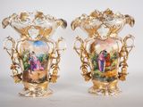 pair of antique porcelain vases with painted scenes on them