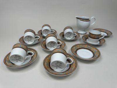 many cups and saucers sitting on the table