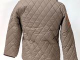 a jacket on a mannequin stand with a white background