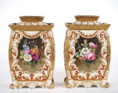 two vases with flowers painted on them sitting side by side