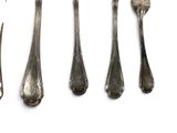 five forks and spoons on a white surface