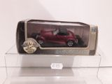 a red toy car in a clear box on a table