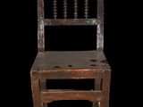 an old wooden chair with a wooden seat on a black background