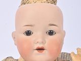 a small doll with a hat on top of it ' s head