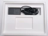 a white box with a charger and a cord in it