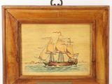 a painting of a ship in a wooden frame hanging on a wall