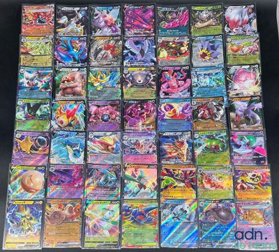 a large collection of pokemon cards sitting on top of a table