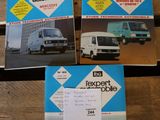 three books on a wooden table with a white van in the background