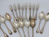 a lot of silver spoons and forks on the table