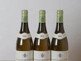 three bottles of wine sitting on top of a wooden table