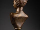 a bronze bust of a boy with a walnut nut