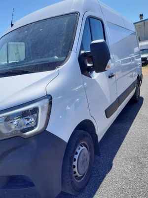 a white van parked in a parking lot next to a building