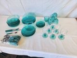 a table with a white table cloth and blue glassware on it