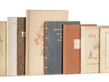 books are lined up in a row on a white surface