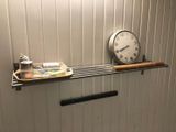 a picture of a bathroom with a clock and a towel rack