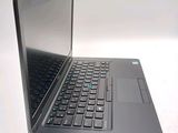 a laptop computer sitting on a table with a keyboard
