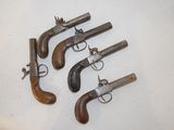 three old revolvers sitting on a white surface with a white background