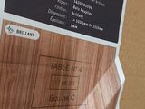 a label on a piece of wood that is on a cardboard box