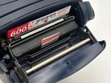 a stapler that has a roll of paper inside of it