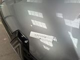 a sticker on the hood of a car that says caution