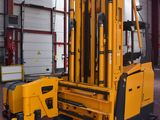 a forklift in a warehouse with a fork on it