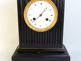 a black and gold clock on a white background