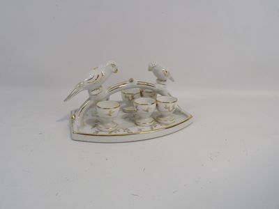 porcelain figurine of two birds sitting on top of a white plate