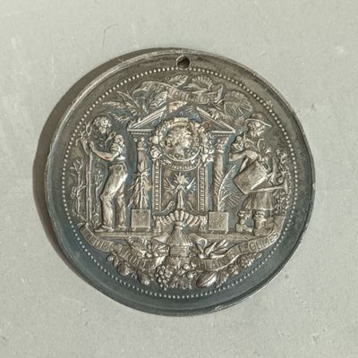 an old silver coin with an image of a man and a woman on it