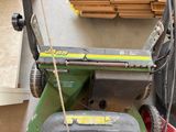 a lawn mower that is sitting on the ground