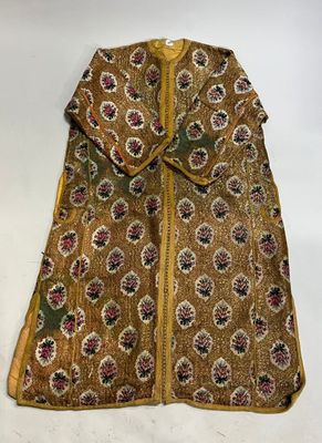 a brown and yellow jacket with a floral design on it