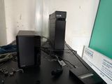 two speakers sitting on a table with wires on it