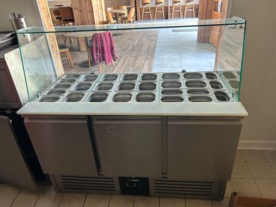 an image of a kitchen with a counter and a refrigerator