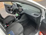 the interior of a car with the door open and the driver ' s seat down
