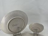 pair of silver plate on stands with writing on them