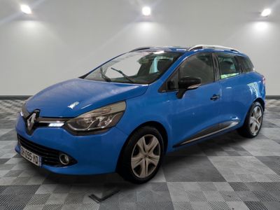 the blue car is parked on a checkered floor in a garage